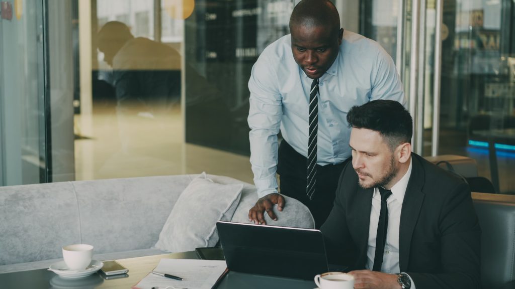 Two colleagues discussing an integrated digital marketing plan
