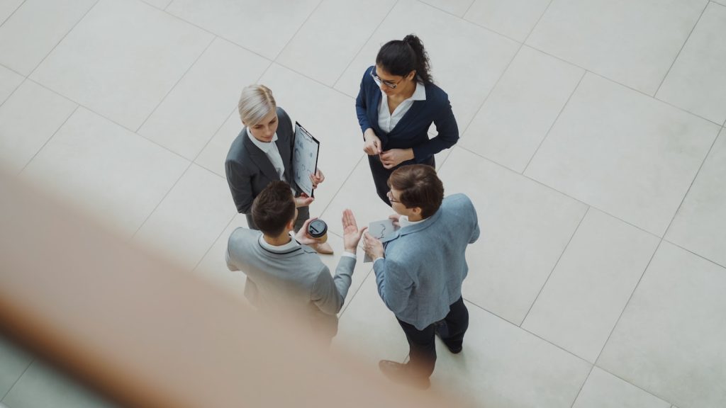 Business people discussing a holistic marketing strategy in an office lobby